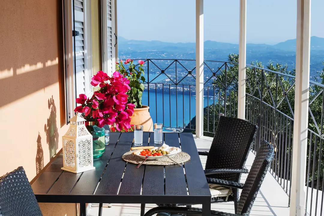 Balcony dining with sea and mountain views